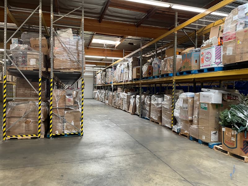 Another picture of warehouse inventory with many towers of wrapped retail boxes